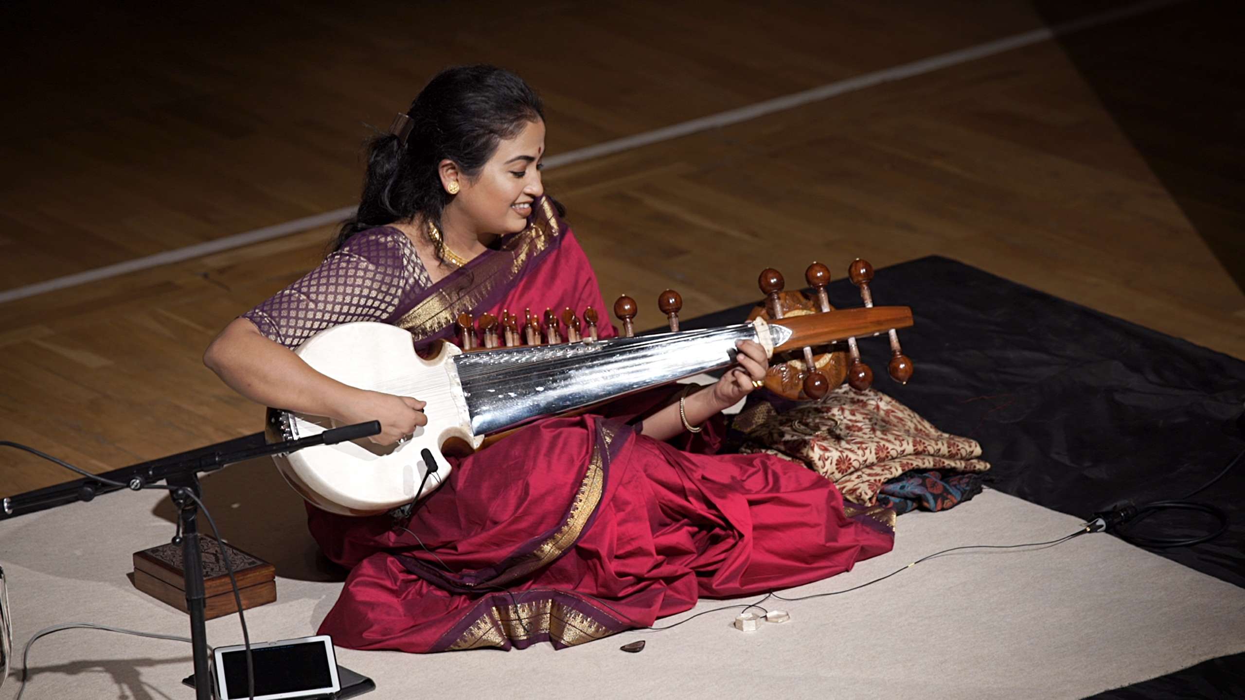 A photo taken from the balcony of Debasmita playing the sarod on stage at St George's.