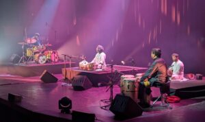 The performers on satellite, Satin Singh on Latin percussion, Anantha Krishnan on mridangam, Talvin Singh on tabla, Marcus Gilmore on drums